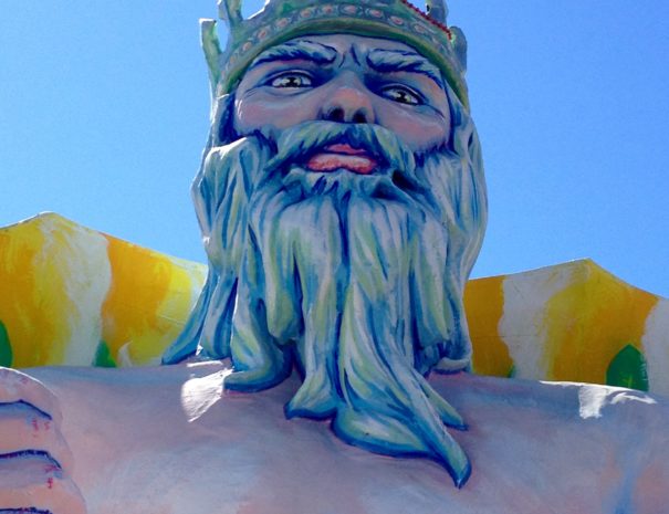 The Greek god Poseidon  glares from atop a Mardi Gras float.